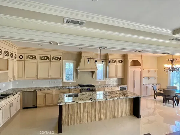 a large kitchen with a lot of counter space and a wooden floor