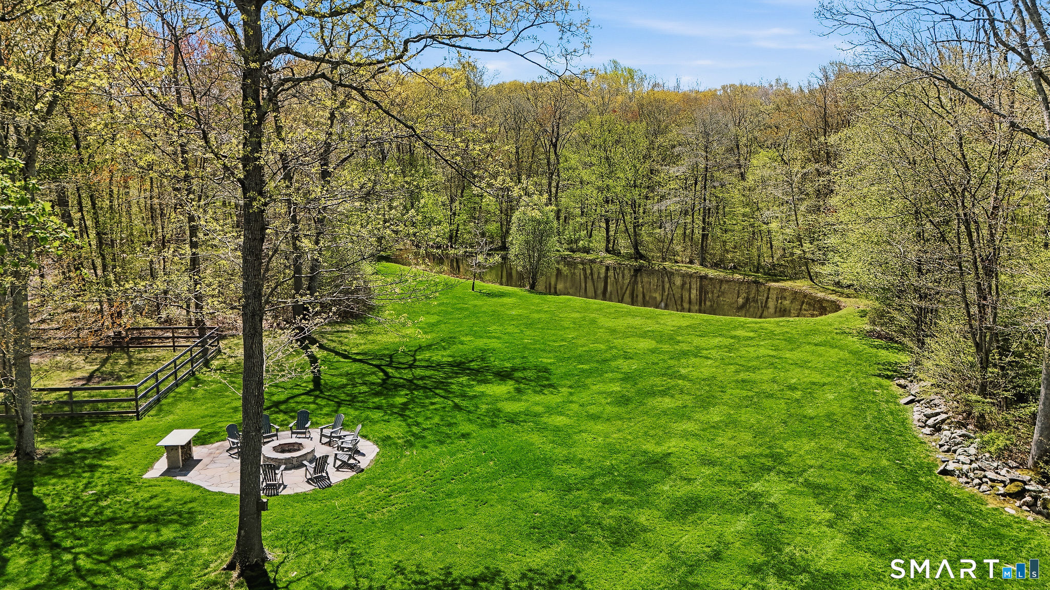 61 Mystic Road North Stonington, CT 06359 - Photo 2 of 40 a view of a wooden house with a yard