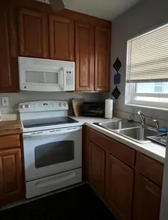 a kitchen with granite countertop cabinets stainless steel appliances and sink
