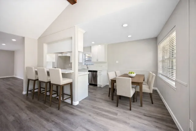 a view of a dining room with furniture and wooden floor