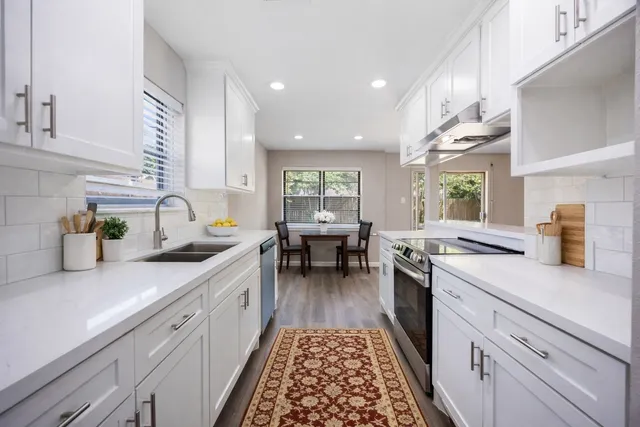 a kitchen with a sink stove and cabinets
