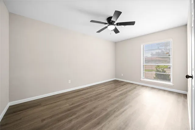 a view of a room with wooden floor and windows