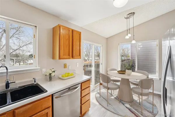 a kitchen that has a sink and view of living room