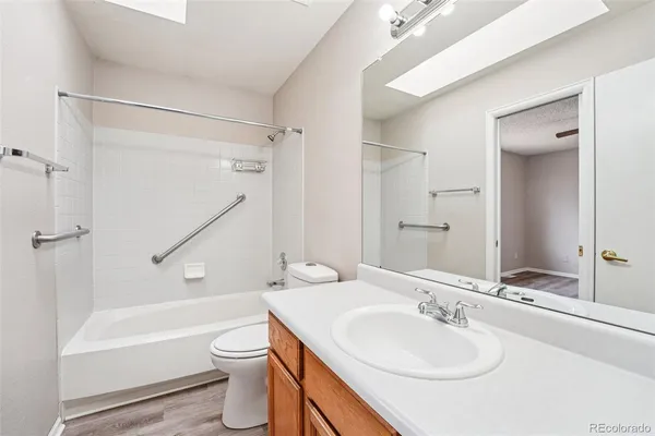 a bathroom with a sink toilet tub and shower