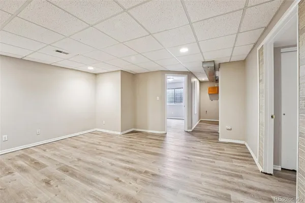 a view of an empty room with wooden floor
