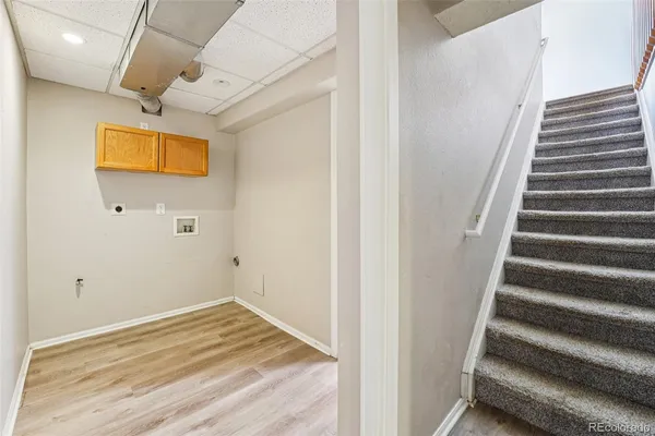 a view of a hallway with wooden floor and staircase