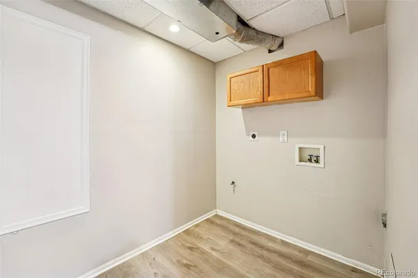 an empty room with windows and wooden floor