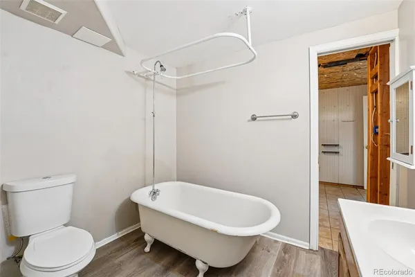 a white toilet sitting next to a bathroom sink