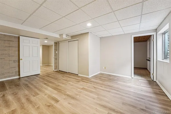 a view of an empty room with wooden floor
