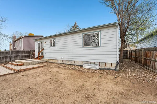 a view of a house with wooden fence