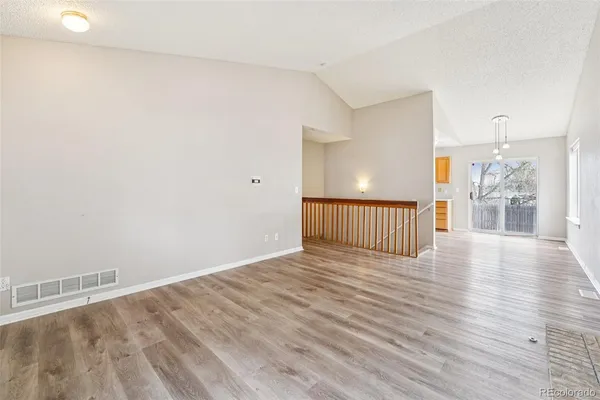 a view of a hallway with wooden floor