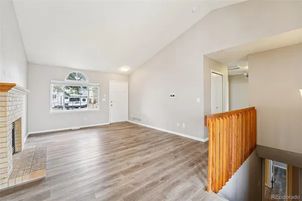 an empty room with wooden floor and a window