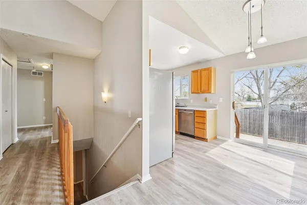 a view of a hallway with wooden floor and staircase