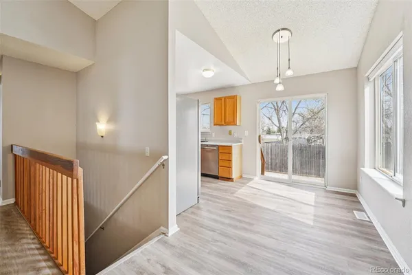 a view of empty room with wooden floor and fireplace