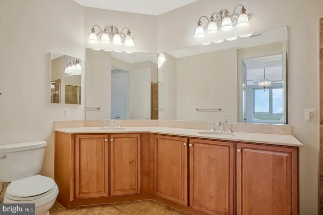 a bathroom with double vanity sink and a mirror