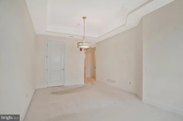 a view of a chandelier fan and closet in a room