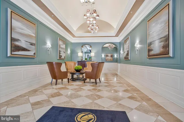 a view of a dining room with furniture a chandelier and wooden floor