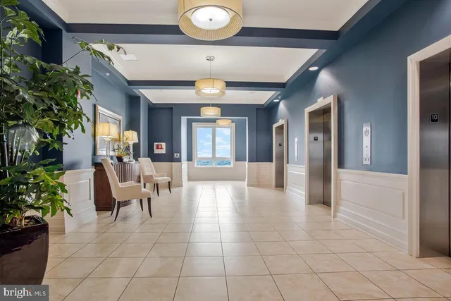 a lobby with furniture and potted plants