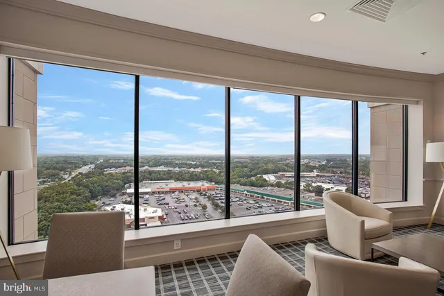 a living room with a large window and a table