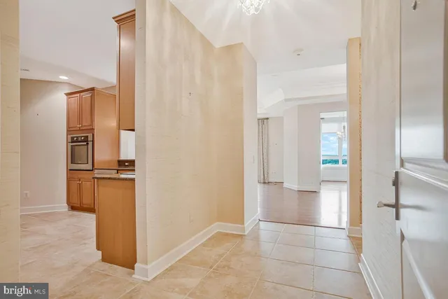 a view of a refrigerator and a kitchen in a house