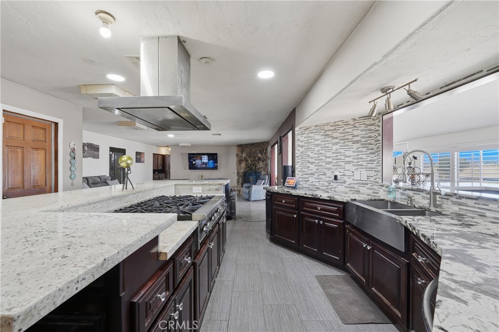 10080 Deep Creek Road Apple Valley, CA 92308 - Photo 13 of 36 a kitchen with stainless steel appliances granite countertop wooden cabinets and sink