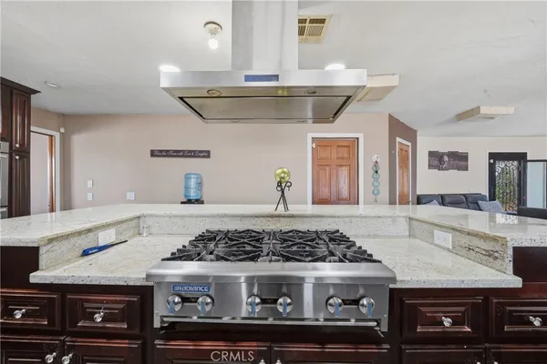 a kitchen with a stove and cabinets