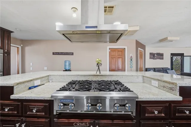 a kitchen with a stove and cabinets