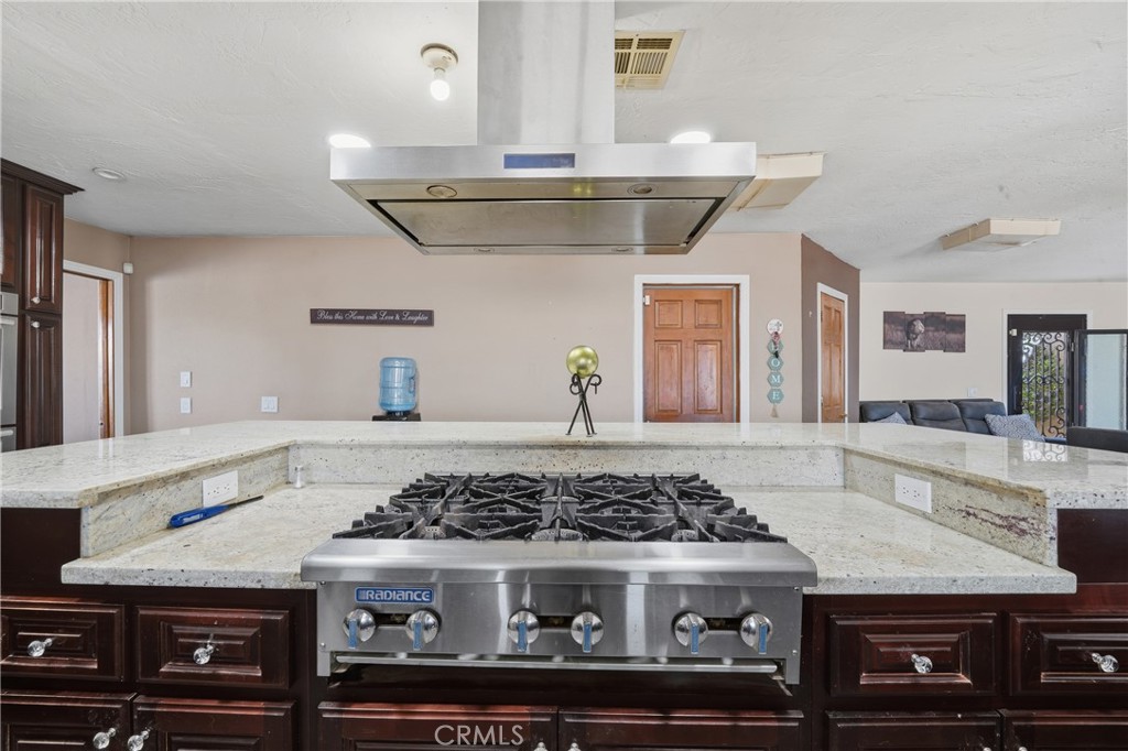 10080 Deep Creek Road Apple Valley, CA 92308 - Photo 14 of 36 a kitchen with a stove and cabinets