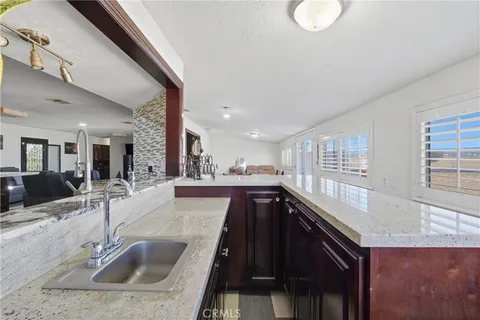 a kitchen with a sink and a large window