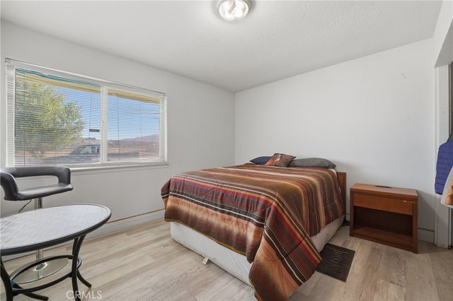 a bedroom with a bed chair and window
