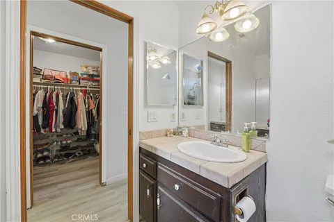 a bathroom with a sink vanity and a mirror