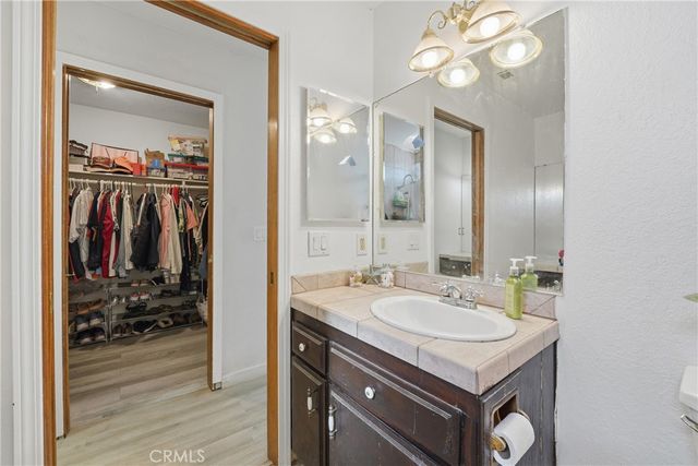 a bathroom with a sink vanity and a mirror