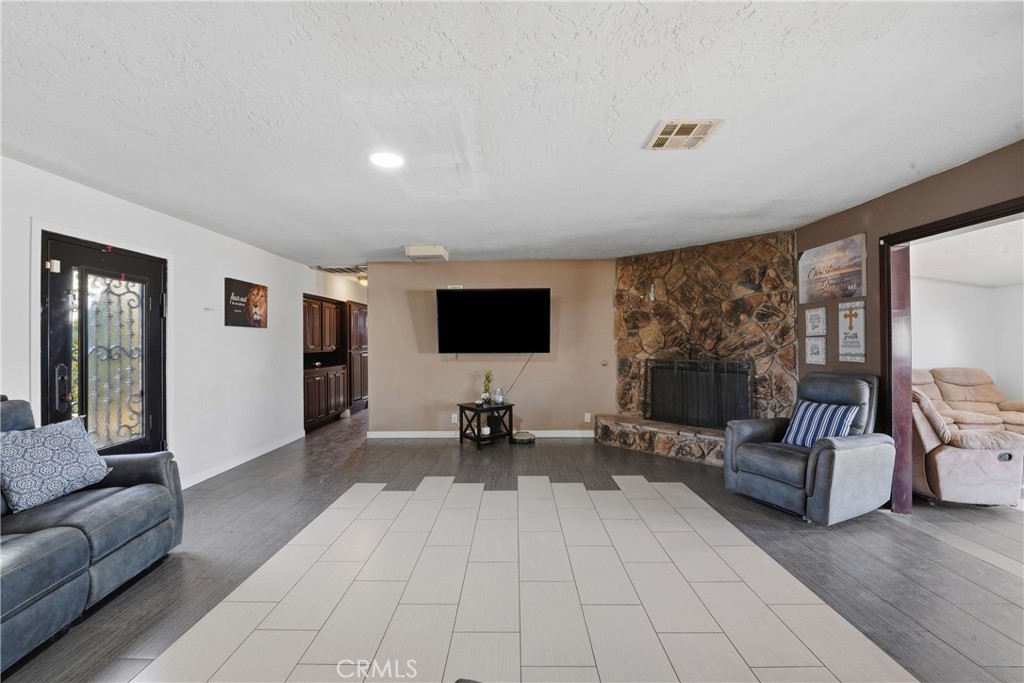10080 Deep Creek Road Apple Valley, CA 92308 - Photo 9 of 36 a living room with furniture and a flat screen tv
