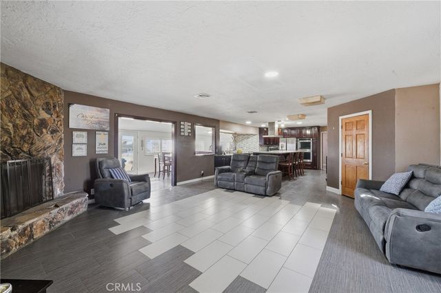 a living room with furniture and large windows