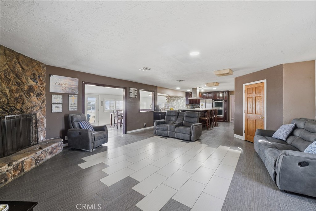 10080 Deep Creek Road Apple Valley, CA 92308 - Photo 10 of 36 a living room with furniture and large windows