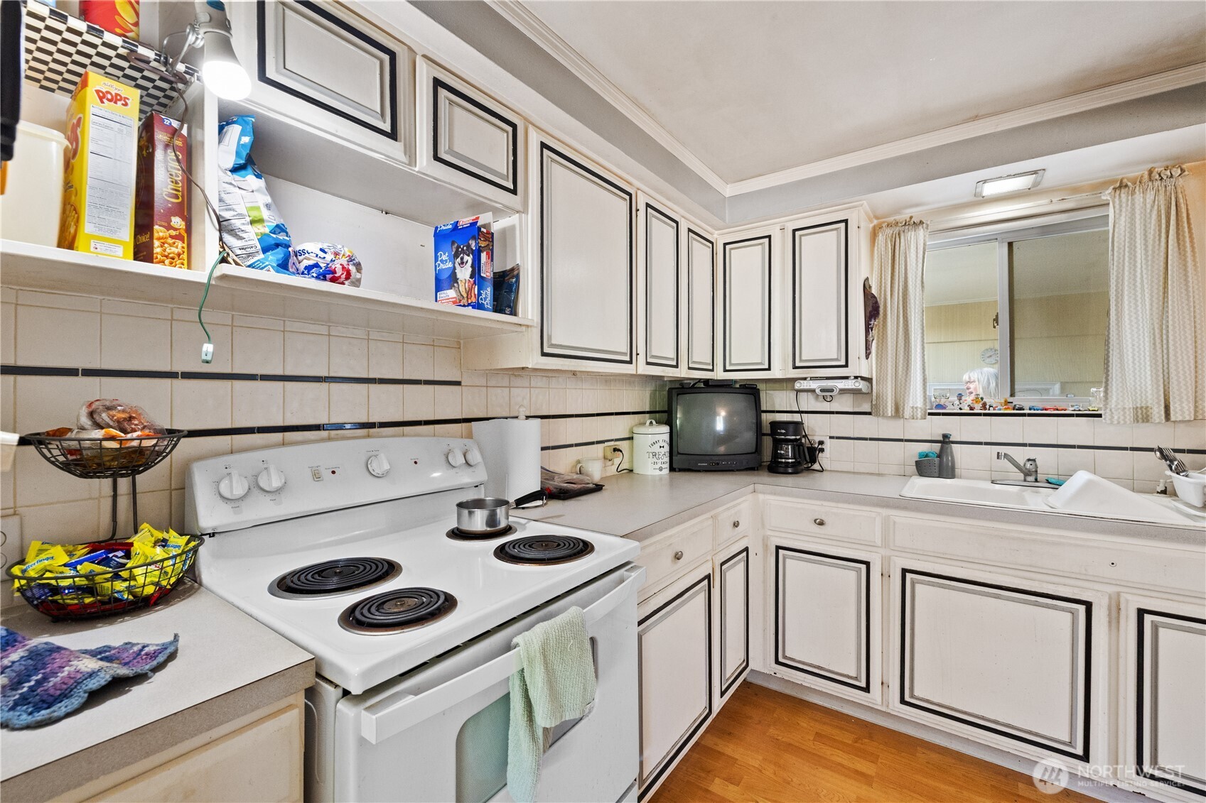 105 Northeast 180th Street Shoreline, WA 98155 - Photo 4 of 34 a kitchen with a sink a stove and cabinets