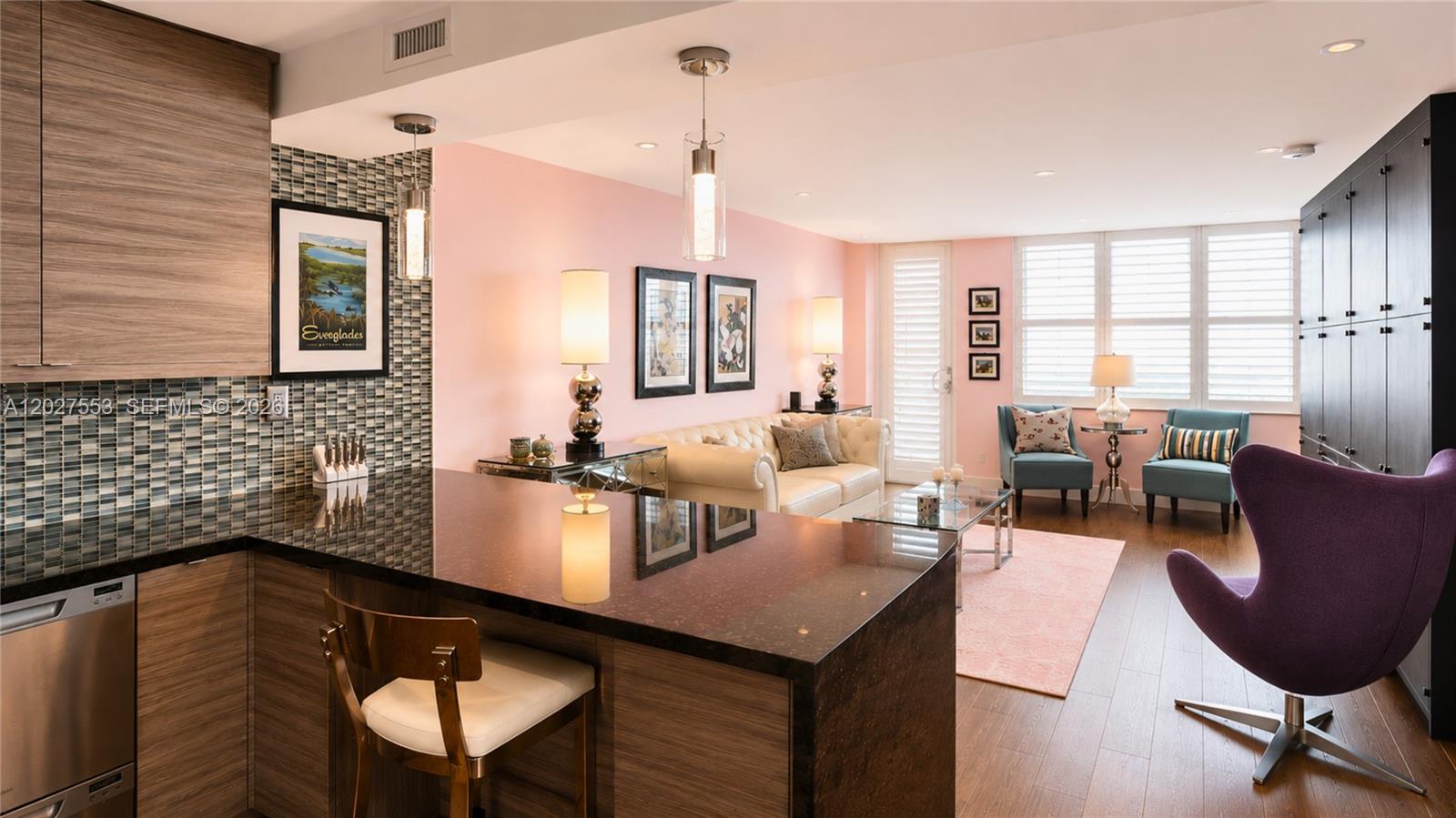 100 Lincoln Road, Unit 533 Miami Beach, FL 33139 - Photo 8 of 26 a kitchen with a table chairs sink and cabinets