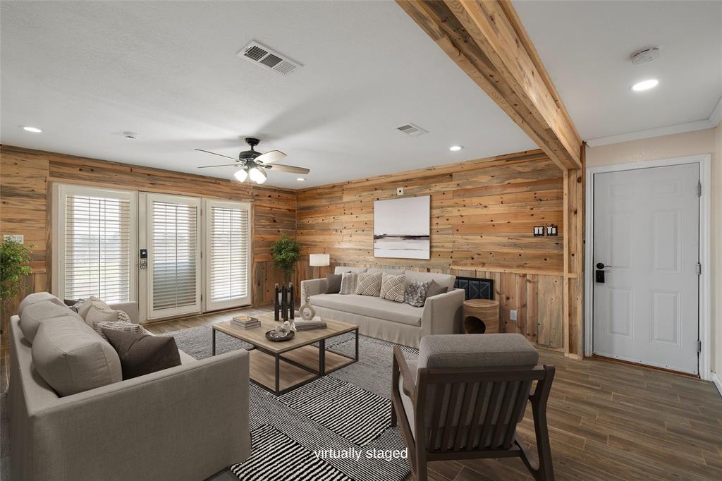 5112 Old Caufield Ranch Road McGregor, TX 76657 - Photo 10 of 38 Living area with wood finished floors, beam ceiling, wood walls, recessed lighting, and ceiling fan