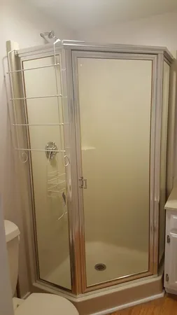 a bathroom with a glass door shower