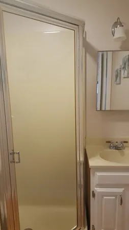 a bathroom with a shower and a sink
