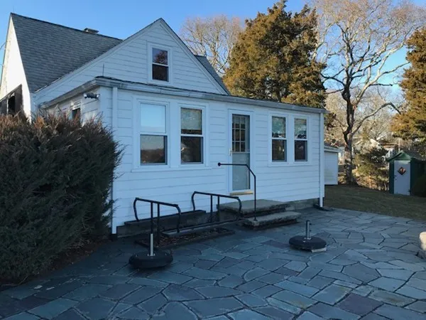 a view of a house with backyard and sitting area