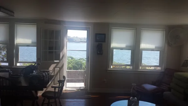 a view of a room with a window and wooden floor