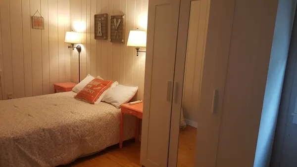 a bedroom with a bed and a mirror