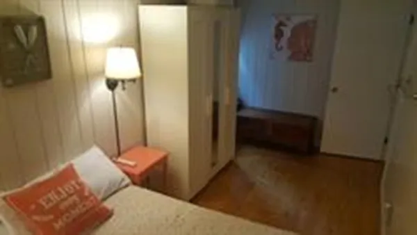 a bedroom with a bed and a mirror