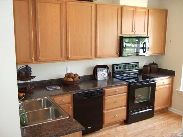 2932 Casona Way Raleigh, NC 27616 - Photo 2 of 12 a kitchen with stainless steel appliances granite countertop a sink stove and cabinets