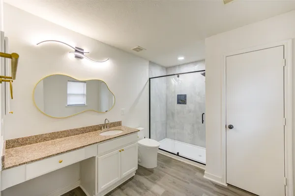 a bathroom with a double vanity sink mirror double and shower