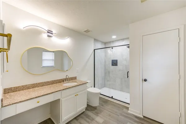 a bathroom with a double vanity sink mirror double and shower