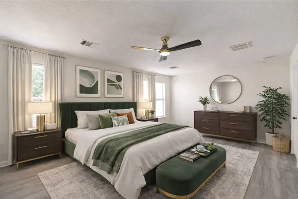 a spacious bedroom with a bed a dresser and a chandelier