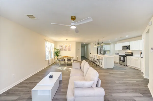 a living room with furniture and kitchen view