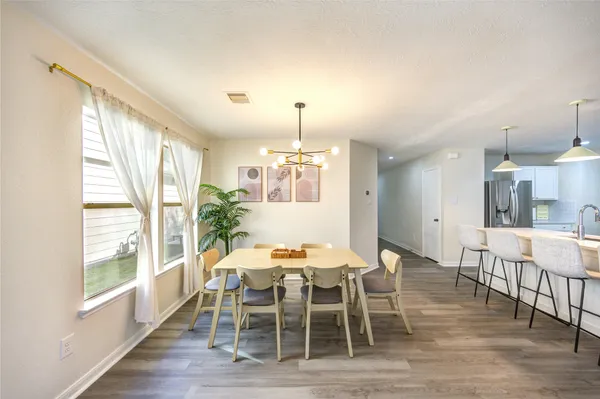 a dining room with furniture and window